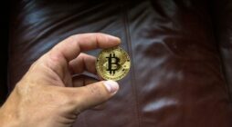 Round Gold-colored and Black Coin on Person's Hand